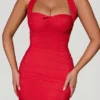 Aisha Bow-Embellished Ruched Halterneck Mini Dress in Red Aisha Bow-Embellished Ruched Halterneck Mini Dress in Red