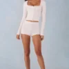Amoura Knit Mid-Rise Mini Shorts in Ivory Amoura Knit Mid-Rise Mini Shorts in Ivory