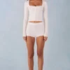 Amoura Knit Mid-Rise Mini Shorts in Ivory Amoura Knit Mid-Rise Mini Shorts in Ivory