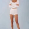 Amoura Knit Mid-Rise Mini Shorts in Ivory Amoura Knit Mid-Rise Mini Shorts in Ivory