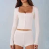 Amoura Knit Mid-Rise Mini Shorts in Ivory Amoura Knit Mid-Rise Mini Shorts in Ivory