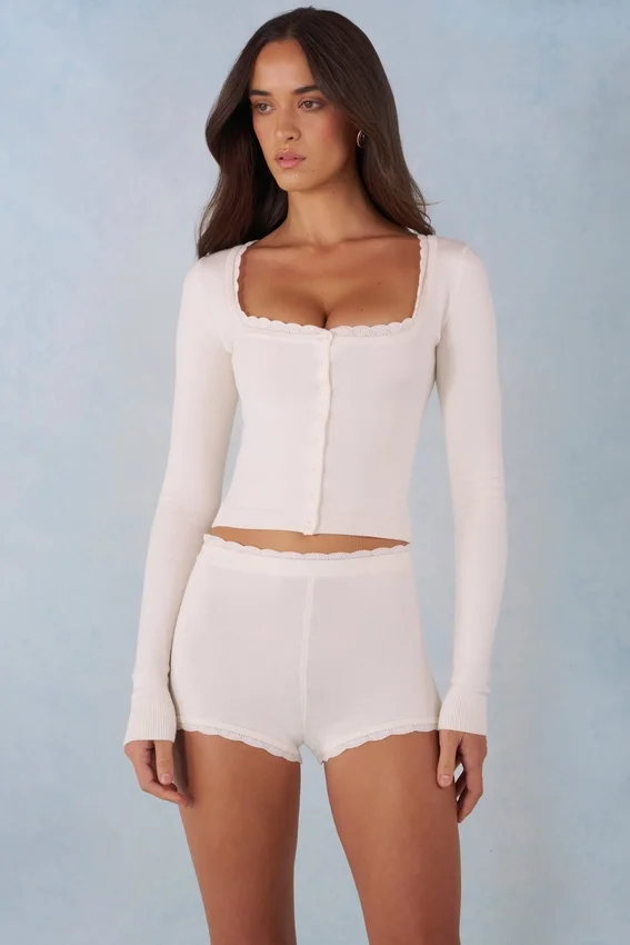 Amoura Knit Mid-Rise Mini Shorts in Ivory Amoura Knit Mid-Rise Mini Shorts in Ivory