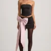 Carola Satin Bow-Detail Low-Rise Mini Skirt in Black Carola Satin Bow-Detail Low-Rise Mini Skirt in Black