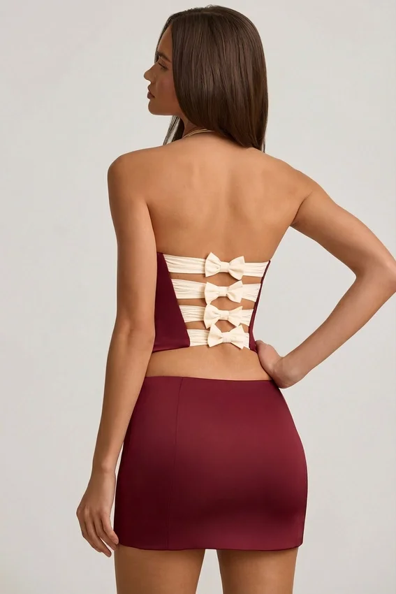 Carola Satin Bow-Detail Low-Rise Mini Skirt in Wine Red Carola Satin Bow-Detail Low-Rise Mini Skirt in Wine Red