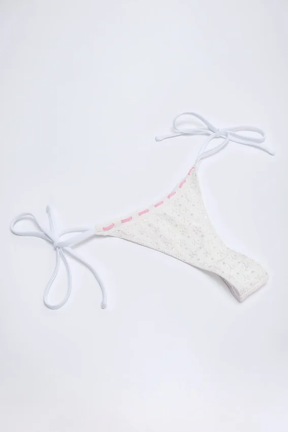 Vernazza Broderie Anglaise Side-Tie Thong Bikini Bottoms in White Vernazza Broderie Anglaise Side-Tie Thong Bikini Bottoms in White
